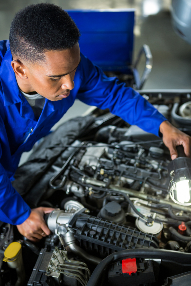 Certified mechanic working on a car engine